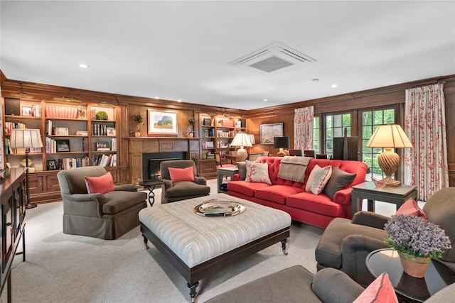 161 Piping Rock Rd, Locust Valley, NY 11560 - living room with a lit fireplace, light carpet, wood walls, recessed lighting, and crown molding