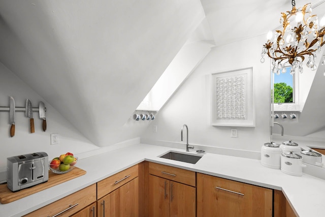 38 Oliphant Ave Unit 6, Dobbs Ferry, NY 10522 - kitchen with a sink, light countertops, a chandelier, hanging light fixtures, and brown cabinetry