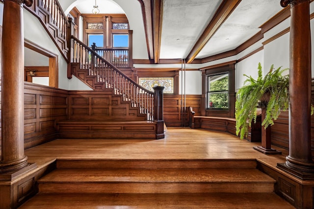 38 Oliphant Ave Unit 6, Dobbs Ferry, NY 10522 - staircase featuring beam ceiling, wood finished floors, a decorative wall, ornate columns, and wainscoting