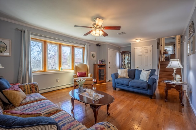 216 Hickory Hill Ln, Newburgh, NY 12550 - living room with baseboard heating, light wood finished floors, ceiling fan, and crown molding
