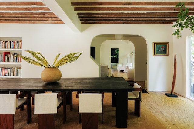 101 Holmes Rd, Newburgh, NY 12550 - dining room with arched walkways, wood-type flooring, and beam ceiling