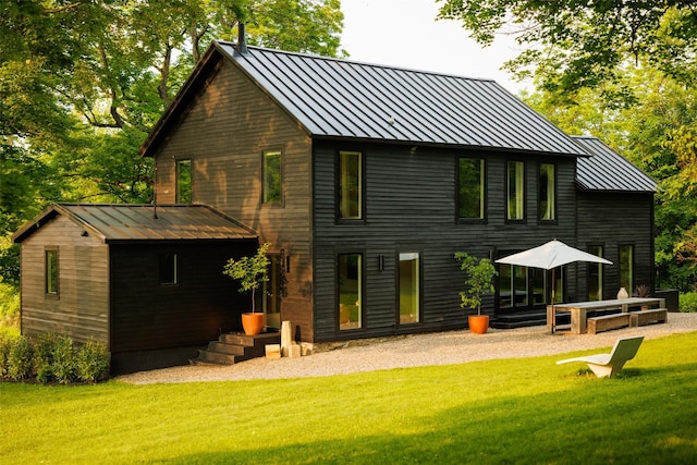101 Holmes Rd, Newburgh, NY 12550 - rear view of property with a standing seam roof, a metal roof, and a lawn