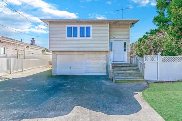 654 Long Island Ave, Deer Park, NY 11729 - view of front of house with brick siding, asphalt driveway, and an attached garage