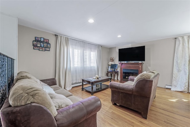 654 Long Island Ave, Deer Park, NY 11729 - living room featuring a fireplace, a baseboard radiator, light wood finished floors, and recessed lighting