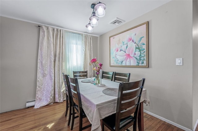 654 Long Island Ave, Deer Park, NY 11729 - dining space with wood finished floors, a baseboard radiator, and baseboards
