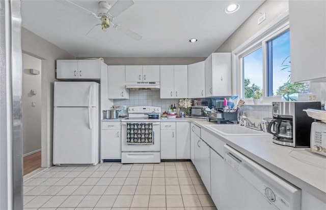 654 Long Island Ave, Deer Park, NY 11729 - kitchen with white appliances, under cabinet range hood, a sink, light countertops, and recessed lighting