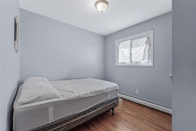 654 Long Island Ave, Deer Park, NY 11729 - bedroom with a baseboard radiator and wood finished floors