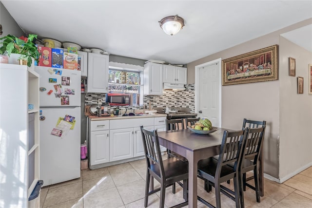 654 Long Island Ave, Deer Park, NY 11729 - kitchen with freestanding refrigerator, under cabinet range hood, black microwave, and decorative backsplash