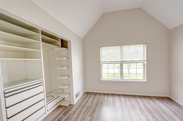 53 Mystic Cir, Bay Shore, NY 11706 - unfurnished bedroom with light wood-type flooring, lofted ceiling, a closet, and baseboards