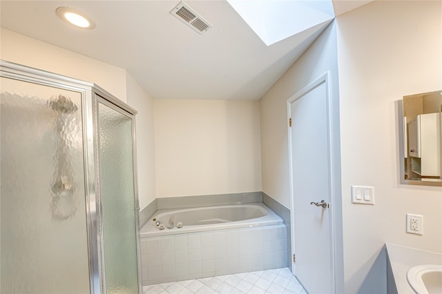 53 Mystic Cir, Bay Shore, NY 11706 - bathroom featuring a shower stall, a garden tub, tile patterned floors, a skylight, and vanity