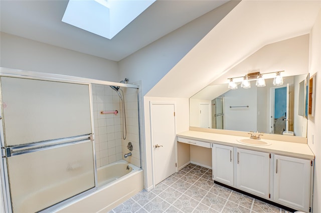 53 Mystic Cir, Bay Shore, NY 11706 - full bathroom featuring a skylight, bath / shower combo with glass door, vanity, and vaulted ceiling