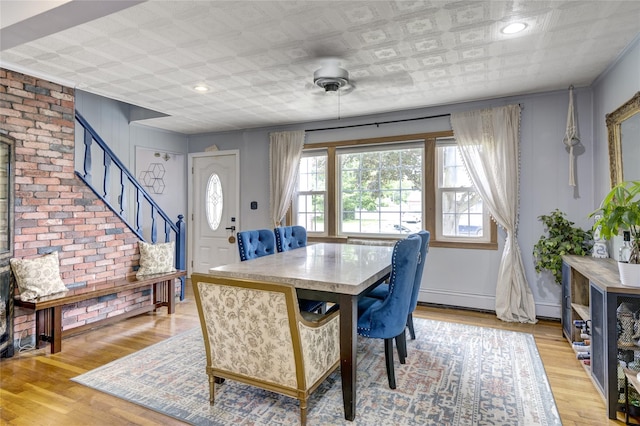 1547 Lincoln Blvd, Bay Shore, NY 11706 - dining room with stairs, light wood finished floors, an ornate ceiling, a ceiling fan, and a baseboard radiator