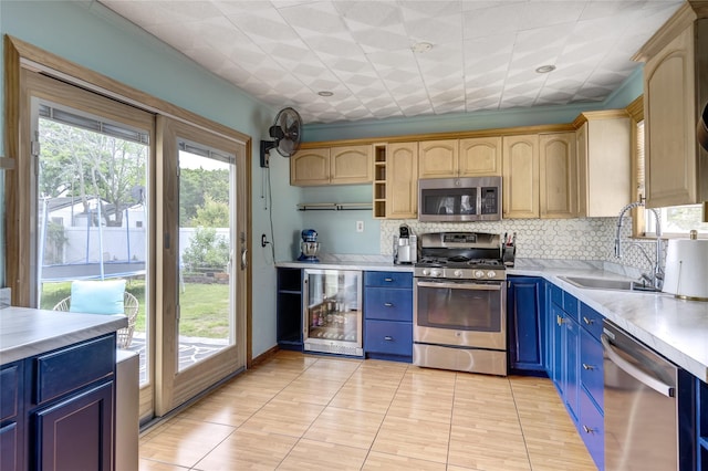 1547 Lincoln Blvd, Bay Shore, NY 11706 - kitchen with stainless steel appliances, beverage cooler, blue cabinetry, a sink, and light countertops