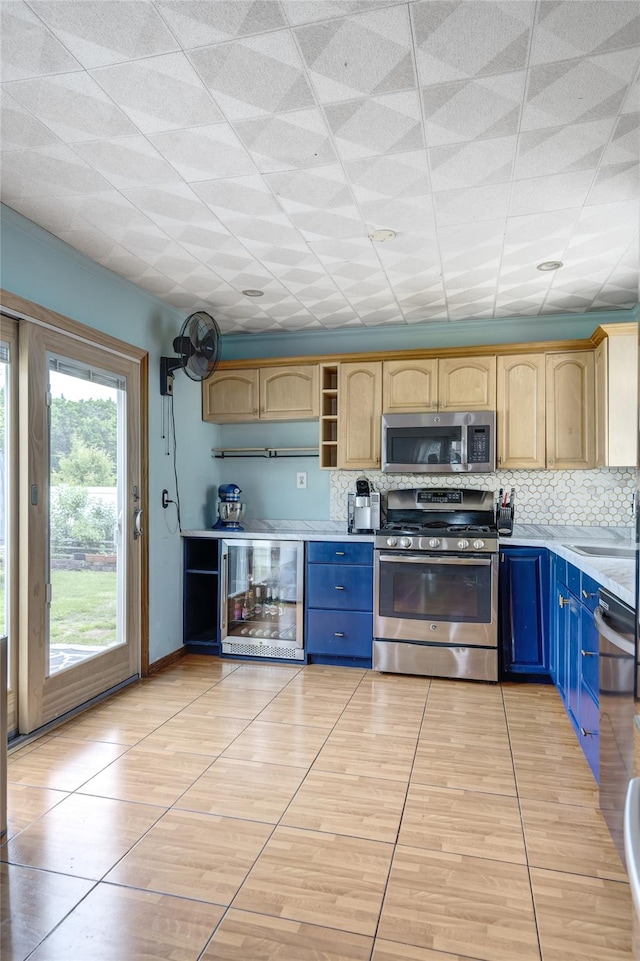 1547 Lincoln Blvd, Bay Shore, NY 11706 - kitchen featuring appliances with stainless steel finishes, beverage cooler, light countertops, light tile patterned floors, and tasteful backsplash