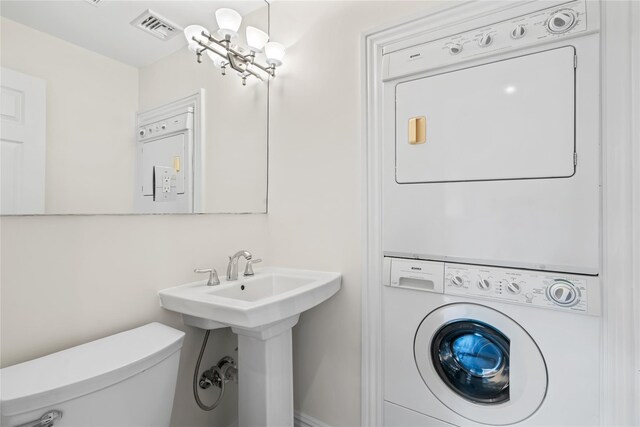 178 High Farms Rd, Old Brookville, NY 11545 - bathroom featuring stacked washer and clothes dryer and toilet
