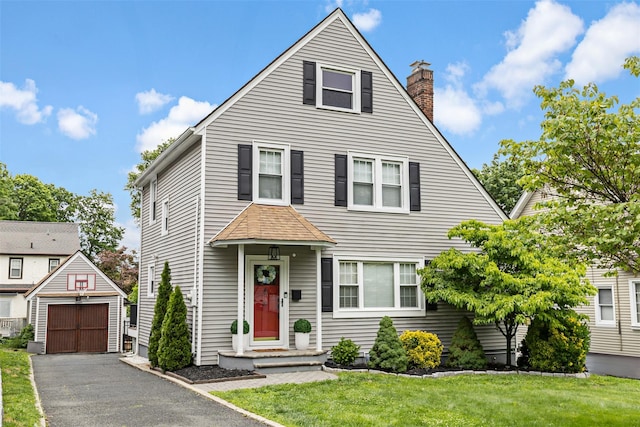 10 Mcbride Ave, White Plains, NY 10603 - view of front of home with a chimney, an outbuilding, a front yard, and a detached garage