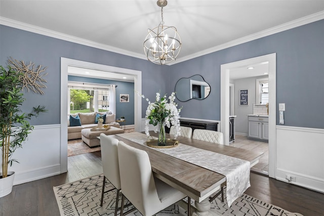 10 Mcbride Ave, White Plains, NY 10603 - dining room featuring plenty of natural light, a chandelier, crown molding, wood finished floors, and wainscoting