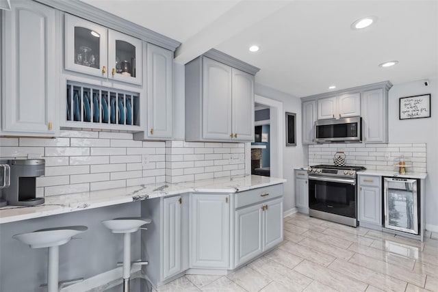 10 Mcbride Ave, White Plains, NY 10603 - kitchen with stainless steel appliances, beverage cooler, gray cabinets, decorative backsplash, and recessed lighting