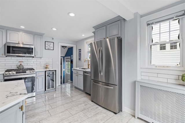 10 Mcbride Ave, White Plains, NY 10603 - kitchen with stainless steel appliances, a sink, beverage cooler, tasteful backsplash, and gray cabinetry