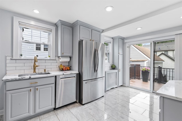 10 Mcbride Ave, White Plains, NY 10603 - kitchen with gray cabinetry, stainless steel appliances, a sink, light marble finish floors, and decorative backsplash