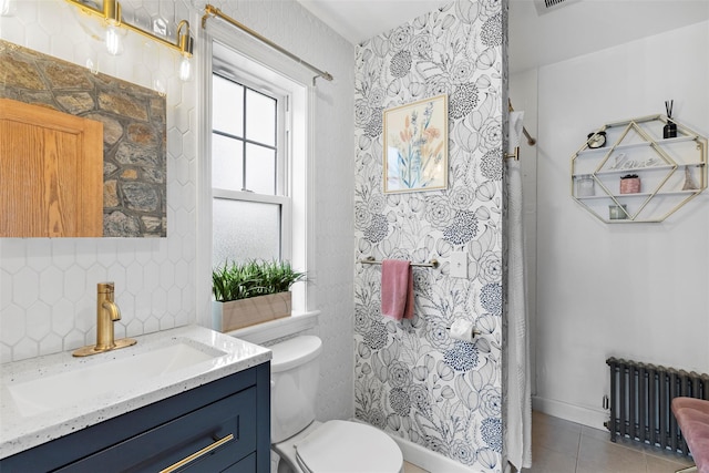 10 Mcbride Ave, White Plains, NY 10603 - bathroom featuring radiator heating unit, tasteful backsplash, vanity, toilet, and tile patterned flooring