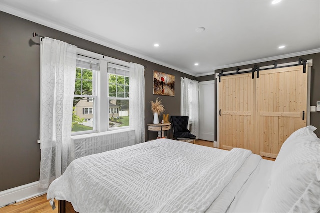 10 Mcbride Ave, White Plains, NY 10603 - bedroom featuring ornamental molding, recessed lighting, wood finished floors, baseboards, and a barn door