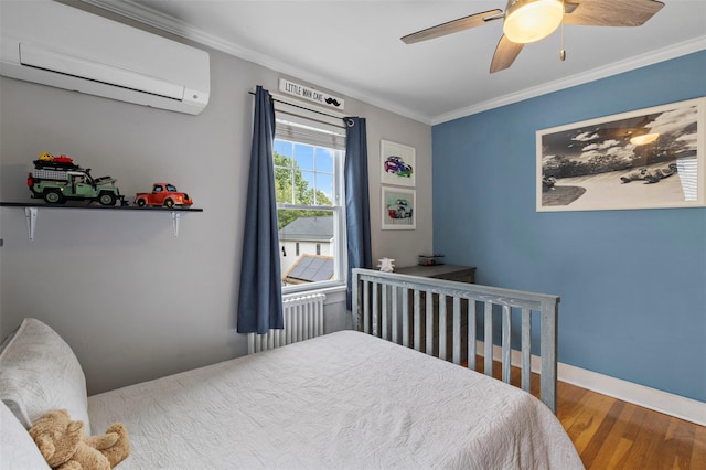 10 Mcbride Ave, White Plains, NY 10603 - bedroom with a wall mounted AC, radiator, wood finished floors, ornamental molding, and baseboards