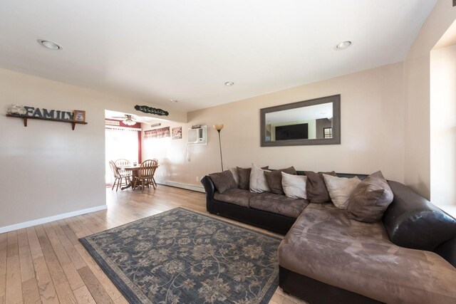 820 Mirabelle Ave, Westbury, NY 11590 - living area with light wood finished floors, a wall unit AC, recessed lighting, and a baseboard heating unit