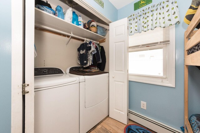 820 Mirabelle Ave, Westbury, NY 11590 - washroom with a baseboard radiator, washer and dryer, and light wood-style flooring