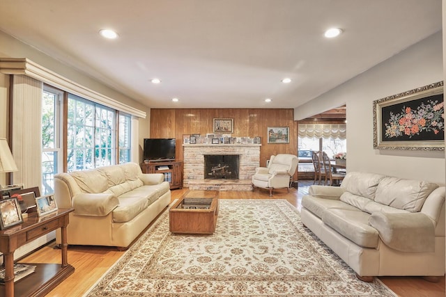 10 Glenbrook Rd, Monsey, NY 10952 - living area featuring recessed lighting, light wood finished floors, a stone fireplace, and wood walls