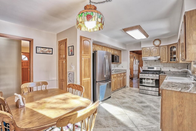 10 Glenbrook Rd, Monsey, NY 10952 - kitchen with appliances with stainless steel finishes, under cabinet range hood, a sink, decorative backsplash, and light tile patterned flooring