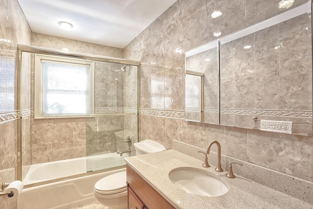 10 Glenbrook Rd, Monsey, NY 10952 - bathroom with tile walls, toilet, vanity, combined bath / shower with glass door, and tasteful backsplash