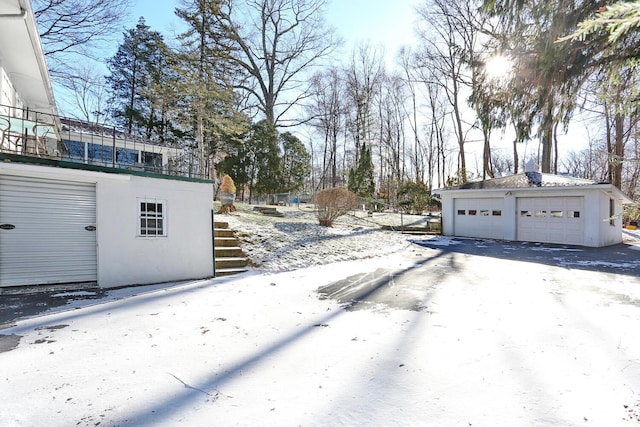 10 Glenbrook Rd, Monsey, NY 10952 - yard layered in snow with an outbuilding and a detached garage