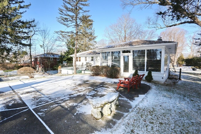 10 Glenbrook Rd, Monsey, NY 10952 - snow covered property featuring a patio area, a chimney, and an outbuilding