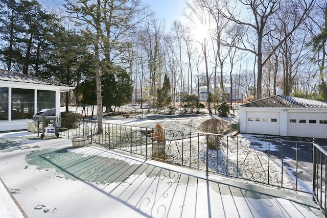 10 Glenbrook Rd, Monsey, NY 10952 - snow covered deck with a sunroom, a garage, a grill, and an outbuilding