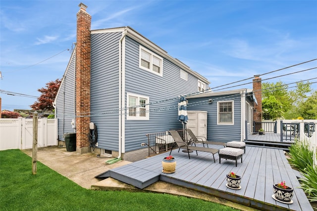 6 Willow Dr, Massapequa Park, NY 11762 - back of property featuring a chimney, a deck, and a gate