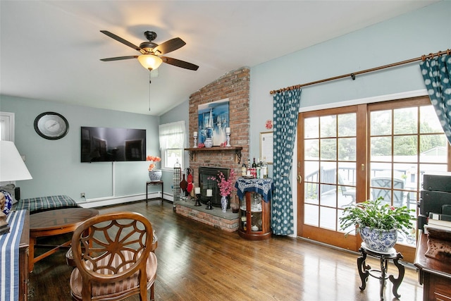 6 Willow Dr, Massapequa Park, NY 11762 - living area featuring vaulted ceiling, a baseboard heating unit, wood finished floors, ceiling fan, and a fireplace
