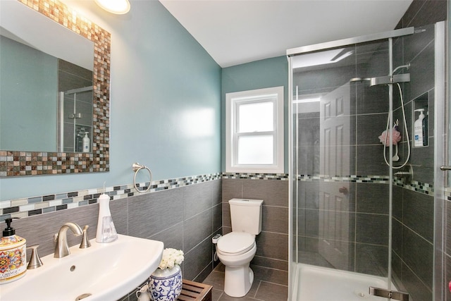 6 Willow Dr, Massapequa Park, NY 11762 - bathroom featuring a sink, tile walls, toilet, a shower stall, and tile patterned floors