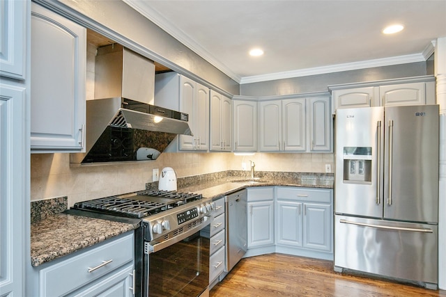 6 Willow Dr, Massapequa Park, NY 11762 - kitchen with stainless steel appliances, ornamental molding, wall chimney range hood, light wood finished floors, and a sink