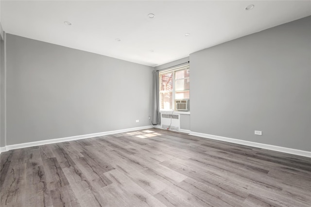 3965 51st St Unit 1C, Woodside, NY 11377 - empty room with wood finished floors, radiator, and baseboards