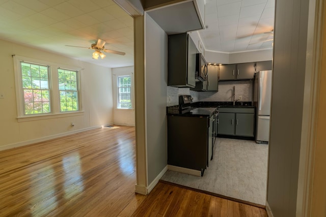 6 Knolls Rd, Poughkeepsie, NY 12601 - kitchen with stainless steel appliances, dark countertops, light wood finished floors, backsplash, and a ceiling fan