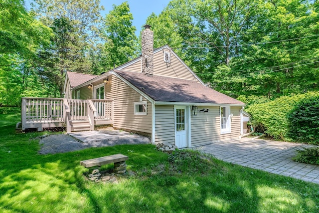 6 Knolls Rd, Poughkeepsie, NY 12601 - rear view of property featuring a wooden deck, a patio area, a chimney, a yard, and roof with shingles
