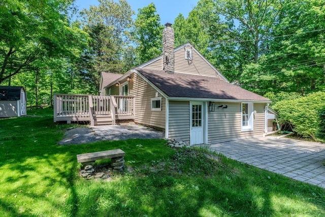 6 Knolls Rd, Poughkeepsie, NY 12601 - back of property featuring a deck, a lawn, a chimney, a shingled roof, and a patio area