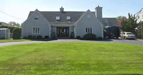 4520 Merrick Rd, Massapequa, NY 11758 - tudor house with a front yard and a chimney