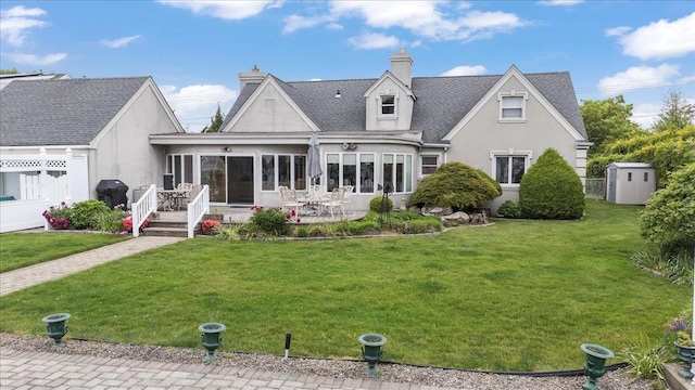 4520 Merrick Rd, Massapequa, NY 11758 - back of property with stucco siding, a yard, a sunroom, a patio, and a chimney