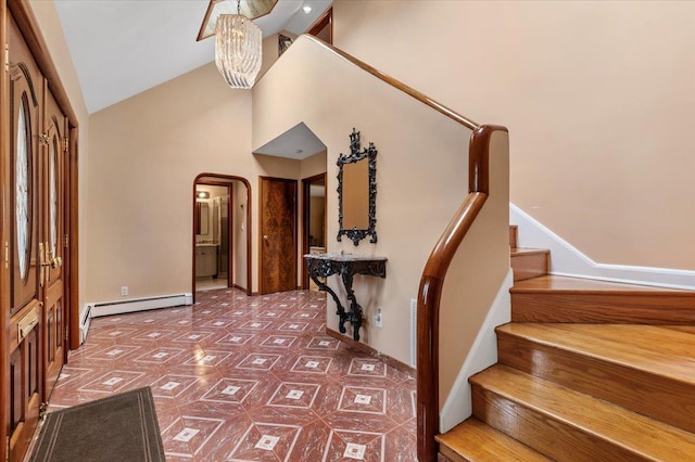 4520 Merrick Rd, Massapequa, NY 11758 - entryway with a baseboard heating unit, arched walkways, stairway, high vaulted ceiling, and baseboards