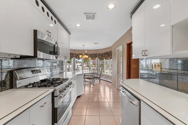 4520 Merrick Rd, Massapequa, NY 11758 - kitchen with stainless steel appliances, a chandelier, light countertops, tasteful backsplash, and recessed lighting