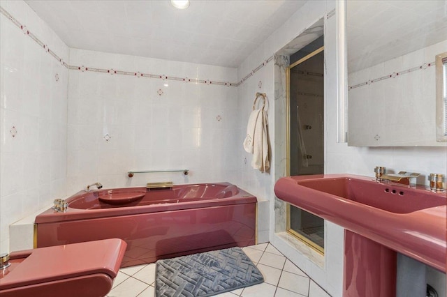 4520 Merrick Rd, Massapequa, NY 11758 - full bathroom featuring tile walls, a bath, a shower stall, tile patterned flooring, and a sink