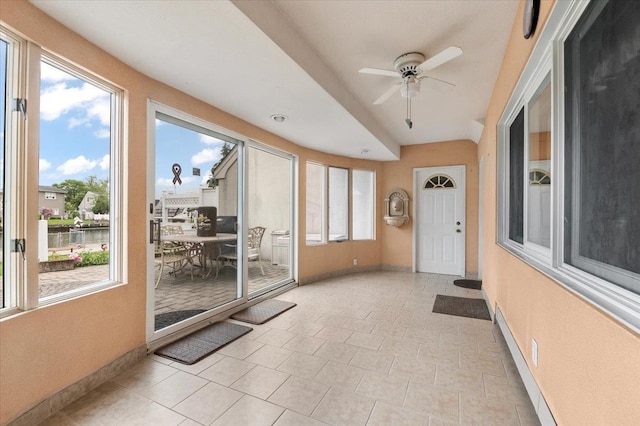 4520 Merrick Rd, Massapequa, NY 11758 - sunroom featuring baseboards, a water view, and tile patterned floors