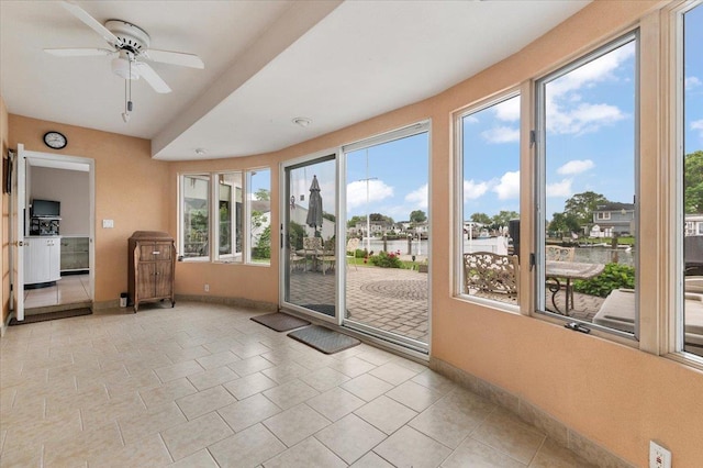 4520 Merrick Rd, Massapequa, NY 11758 - doorway to outside with baseboards, ceiling fan, and tile patterned flooring